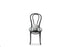 A 20cm white ceramic ball vase with foot sitting on a black bentwood chair with white background.