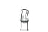 A 25cm clear glass vase sitting on a black bentwood chair with white wall background.