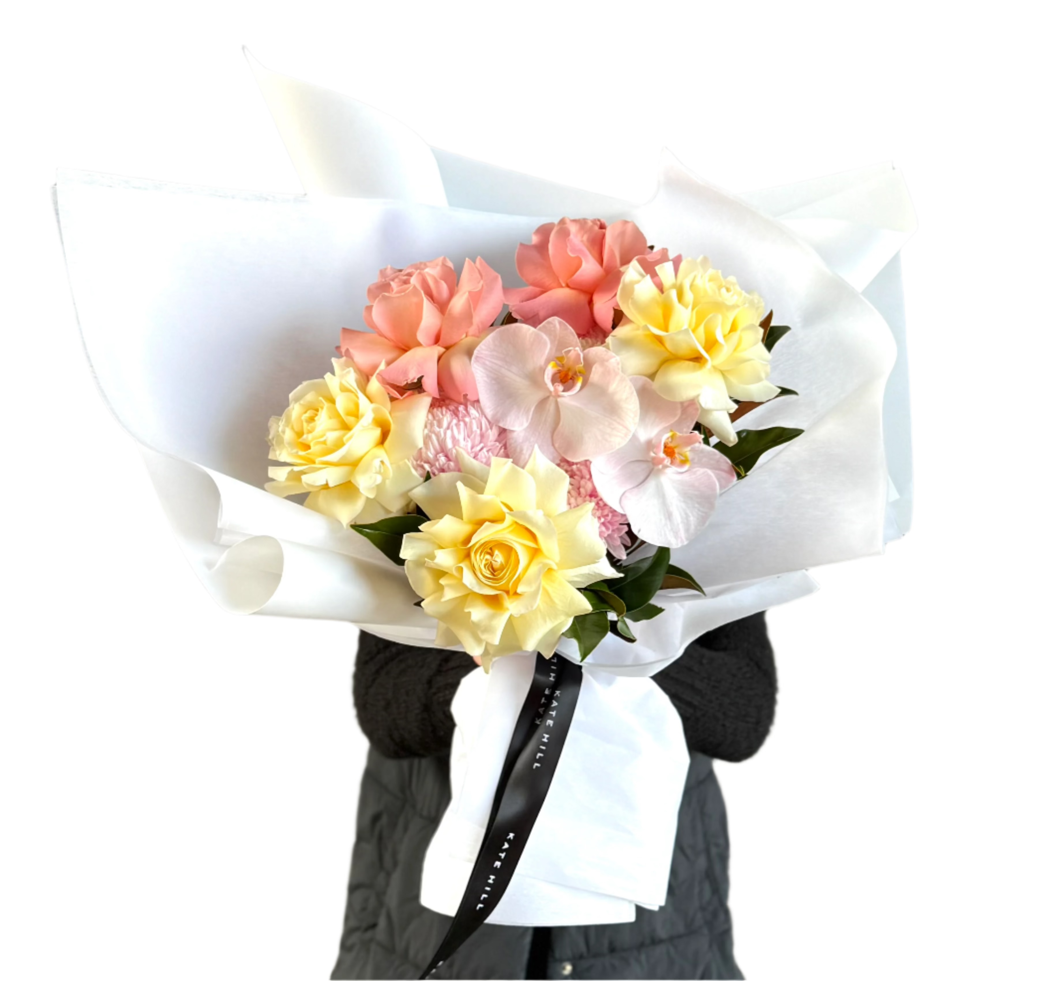 Close up image of florist holding a lemon and blush bouquet in front of a white wall.