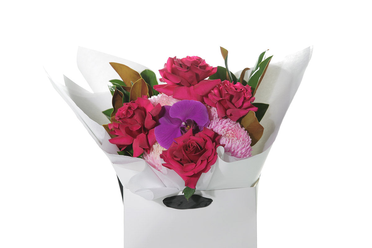 Kate Hill Flowers – medium hot-pink birthday bouquet featuring roses, hydrangeas and magenta orchids hand-tied.