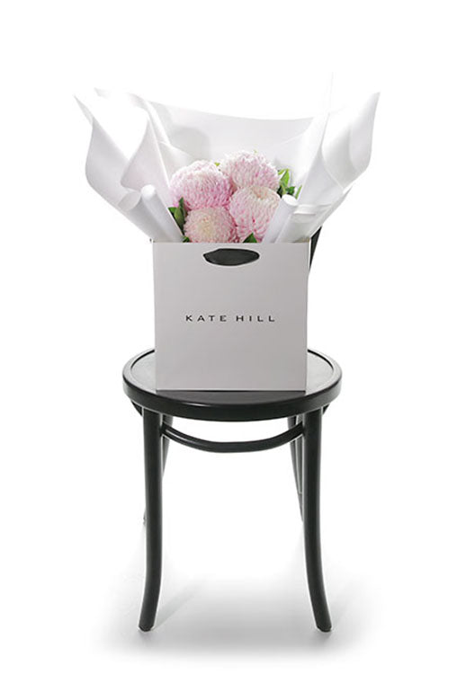 Flower Bouquet in white Kate Hill bag on black bentwood chair