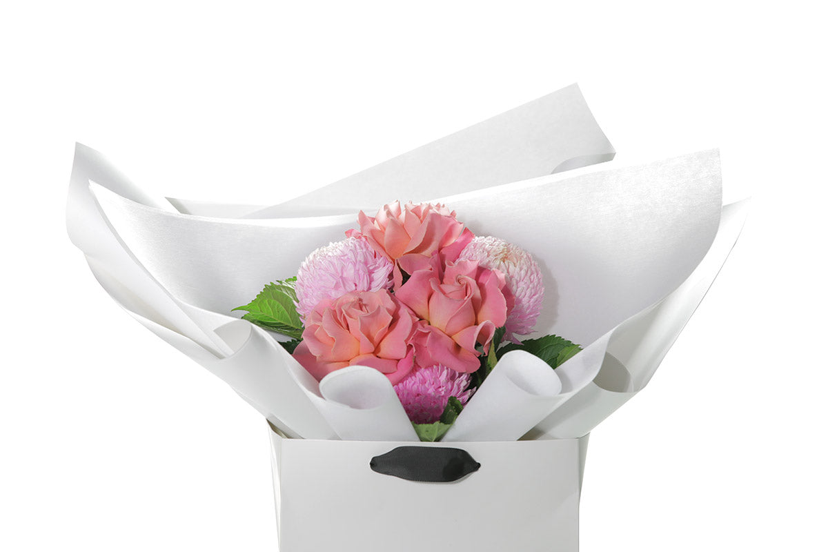 Kate Hill Flowers – petite blush and watermelon birthday posy with roses, hydrangeas and foliage hand-tied.