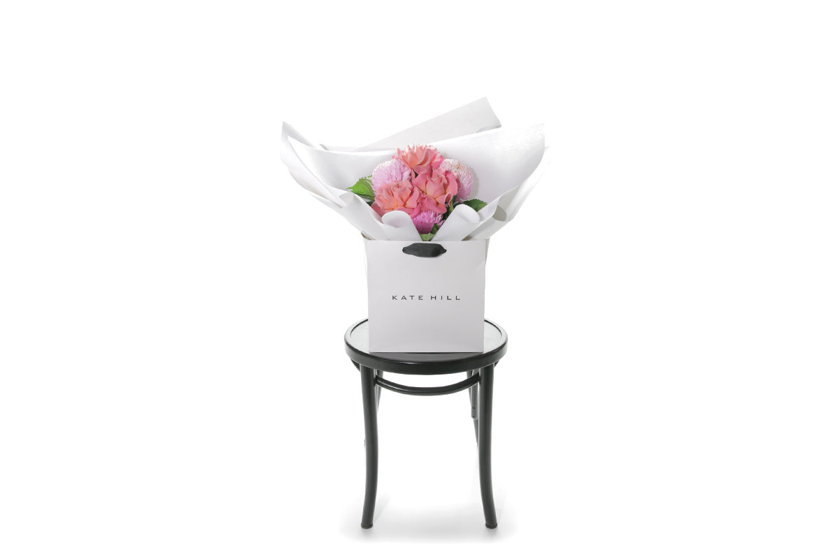 Kate Hill Flowers – petite blush and watermelon birthday posy with roses, hydrangeas and foliage hand-tied.