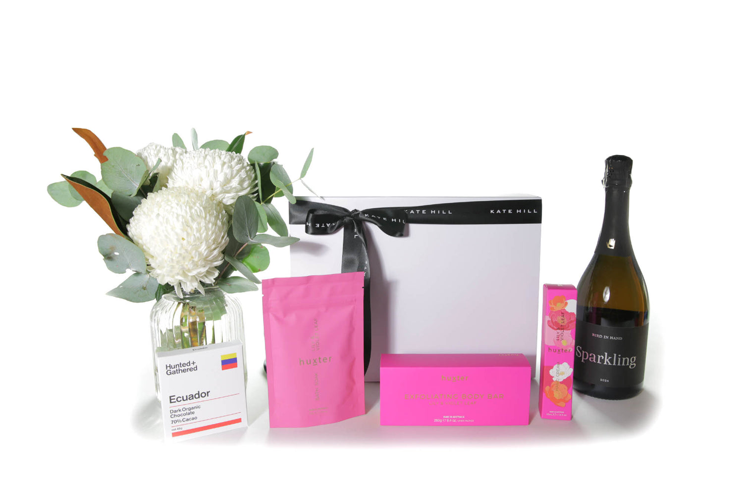 Flower gift box hamper with flowers in a vase, chocolate, body care products and a bottle of Australian sparkling wine.