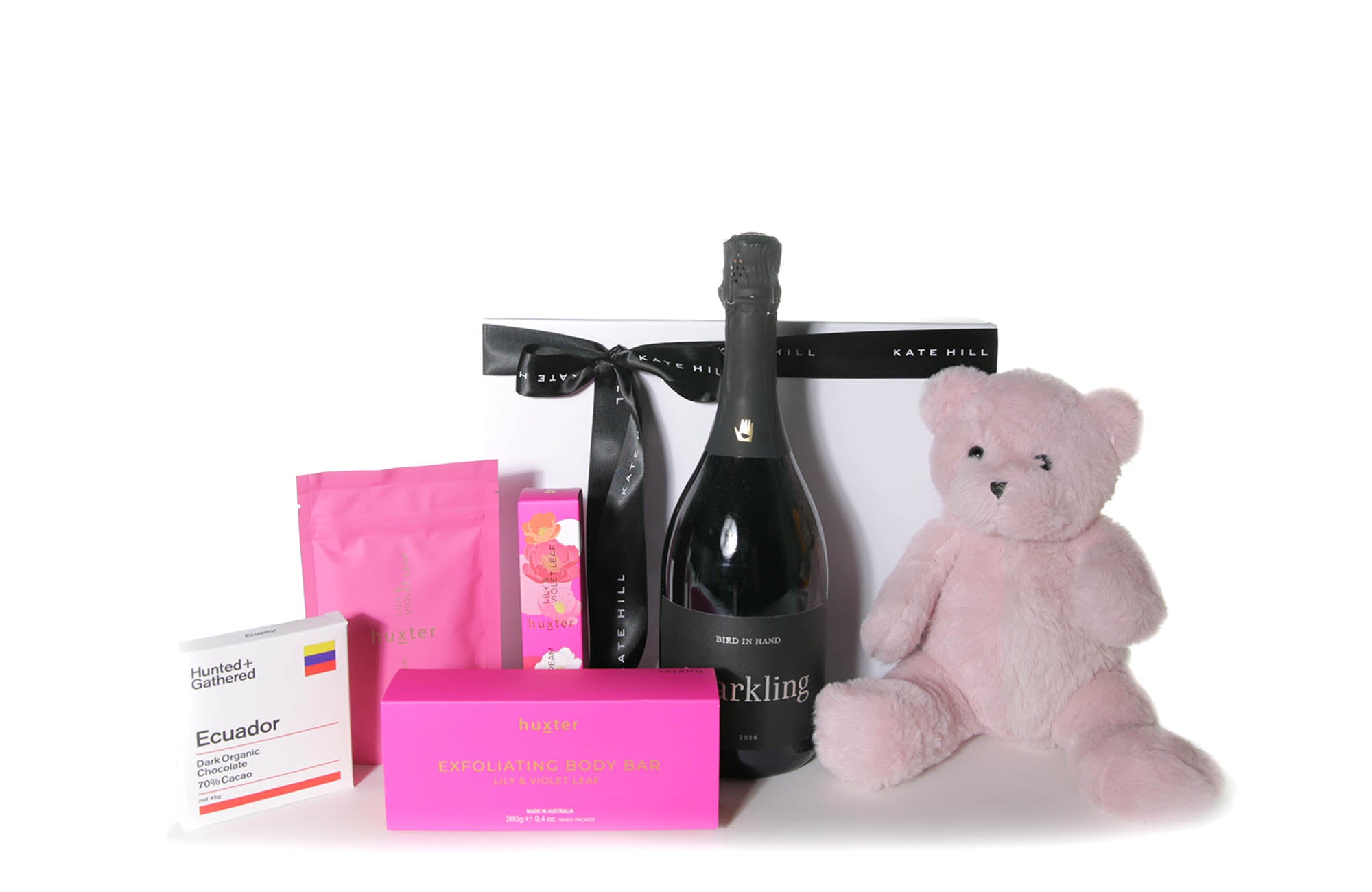 Gift box hamper featuring a chocolate bar, body care pack, sparkling Australian wine and a teddy bear.