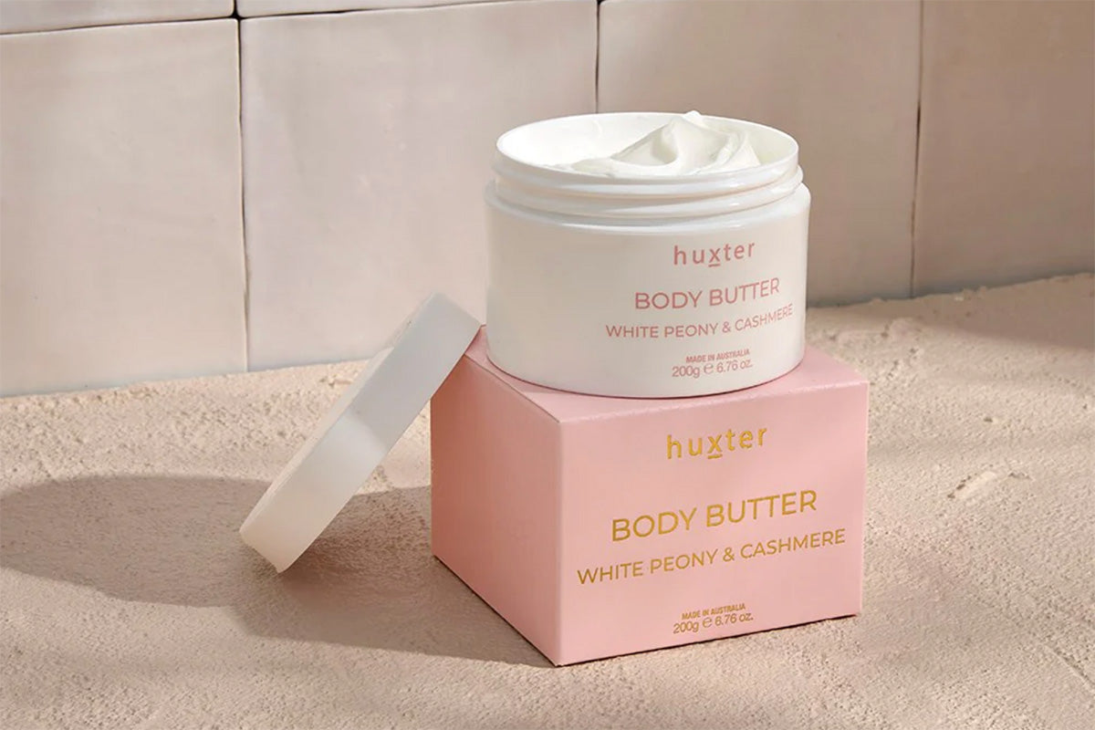Hustler white peony and cashmere Body Butter jar and packaging on a neutral bathroom style background