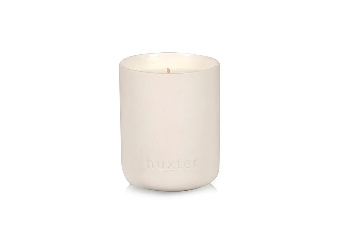 White candle in a ceramic holder with &