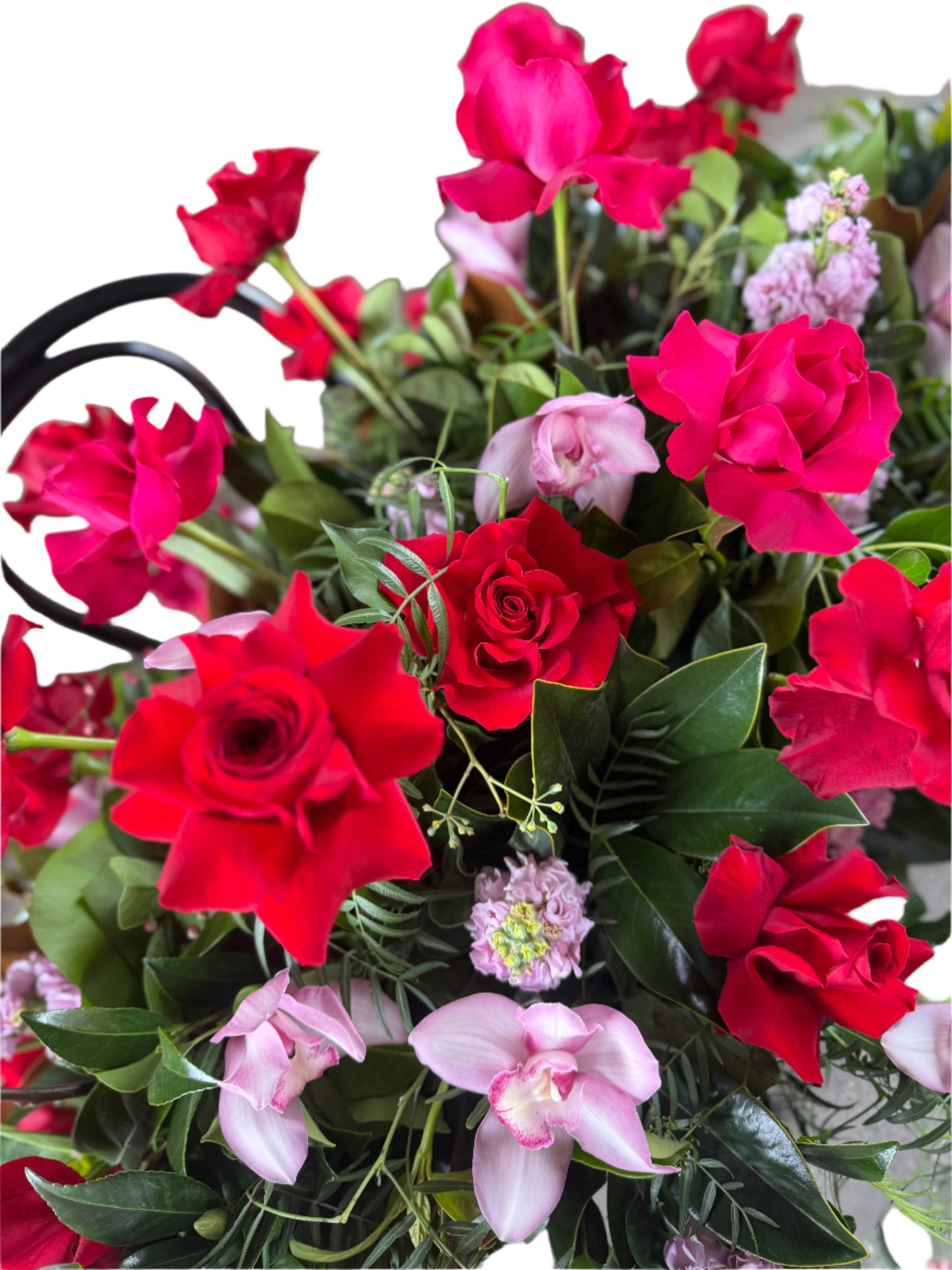 A close up of a hot pink and pale pink casket spray for a funeral casket.