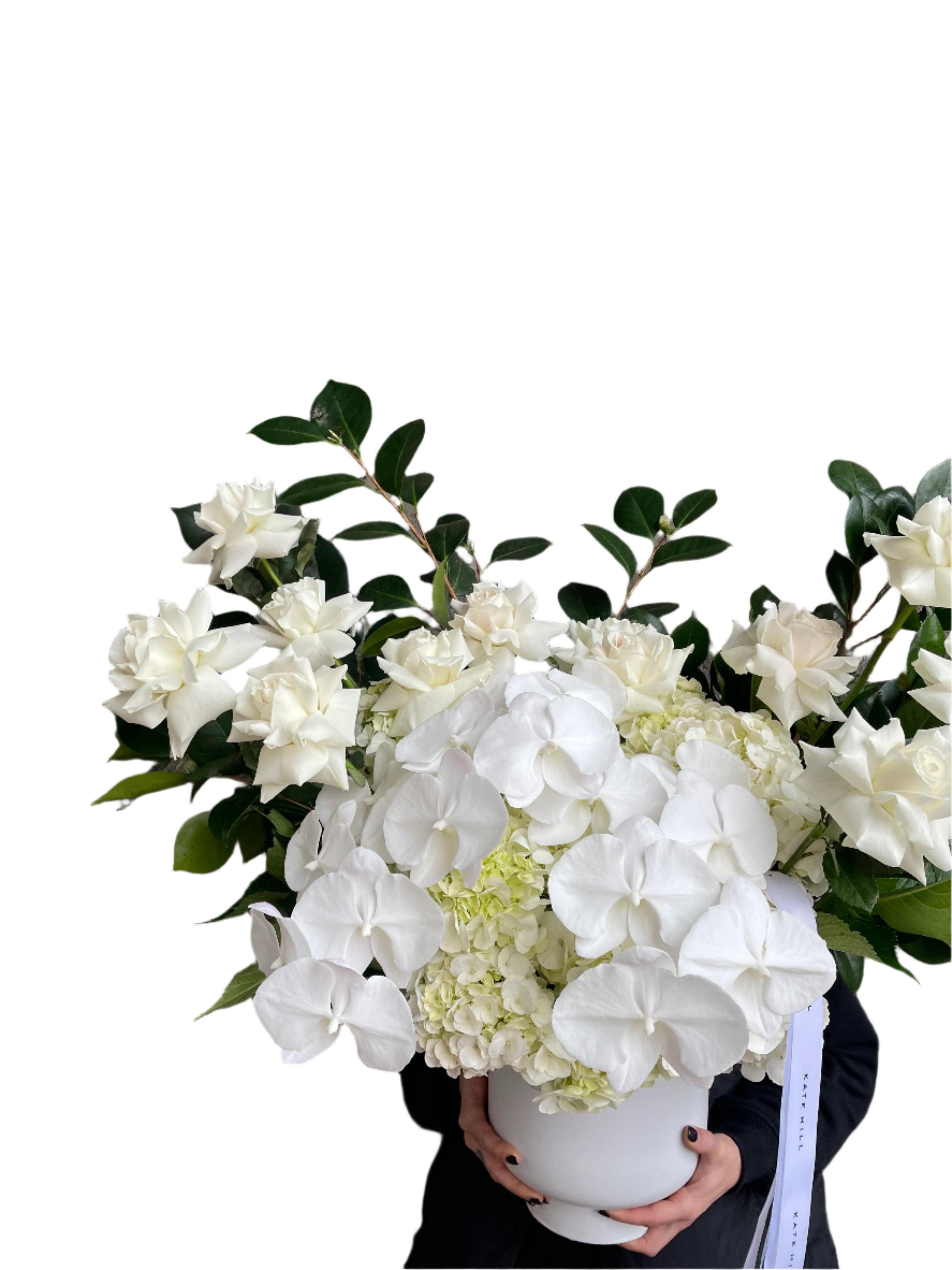 Close up image of A large luxe white flower design sitting on a black bentwood chair with white wall behind.