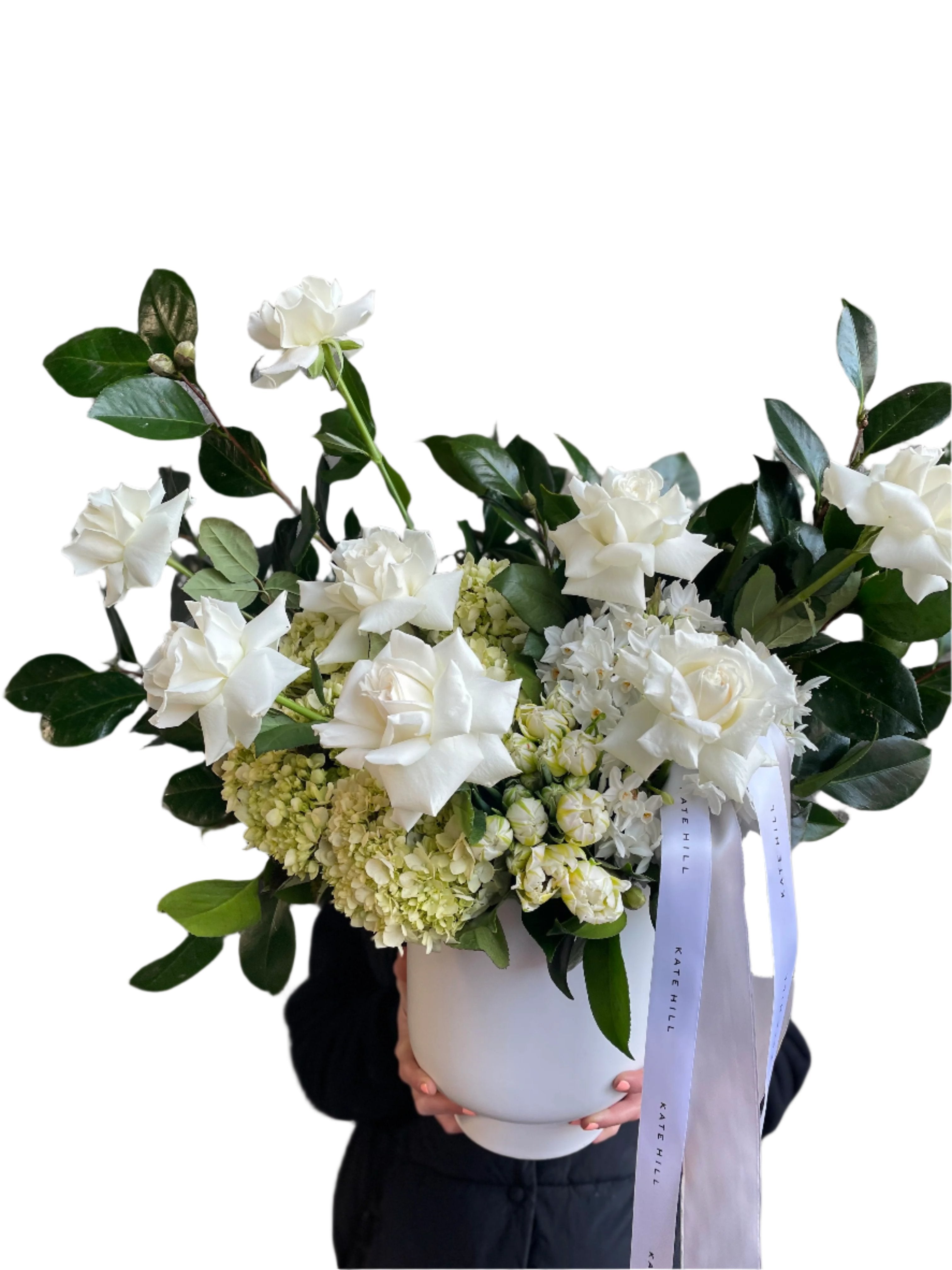 A large luxe white flower design sitting on a black bentwood chair with white wall behind.