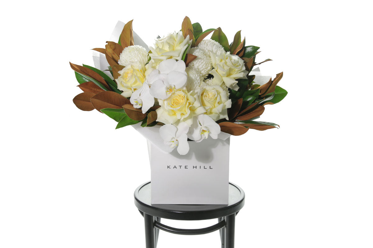 Kate Hill Flowers – large lemon and white thank-you bouquet of roses, chrysanthemums, orchids and magnolia foliage, hand-tied.