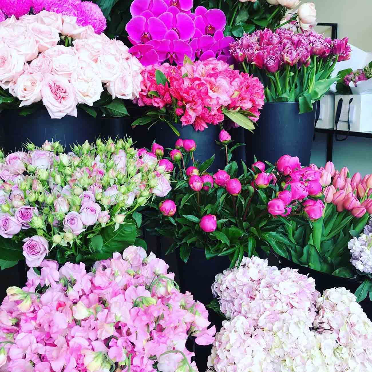 Assorted pink and white flowers in black pots at Melbourne florist Kate Hill Flowers.