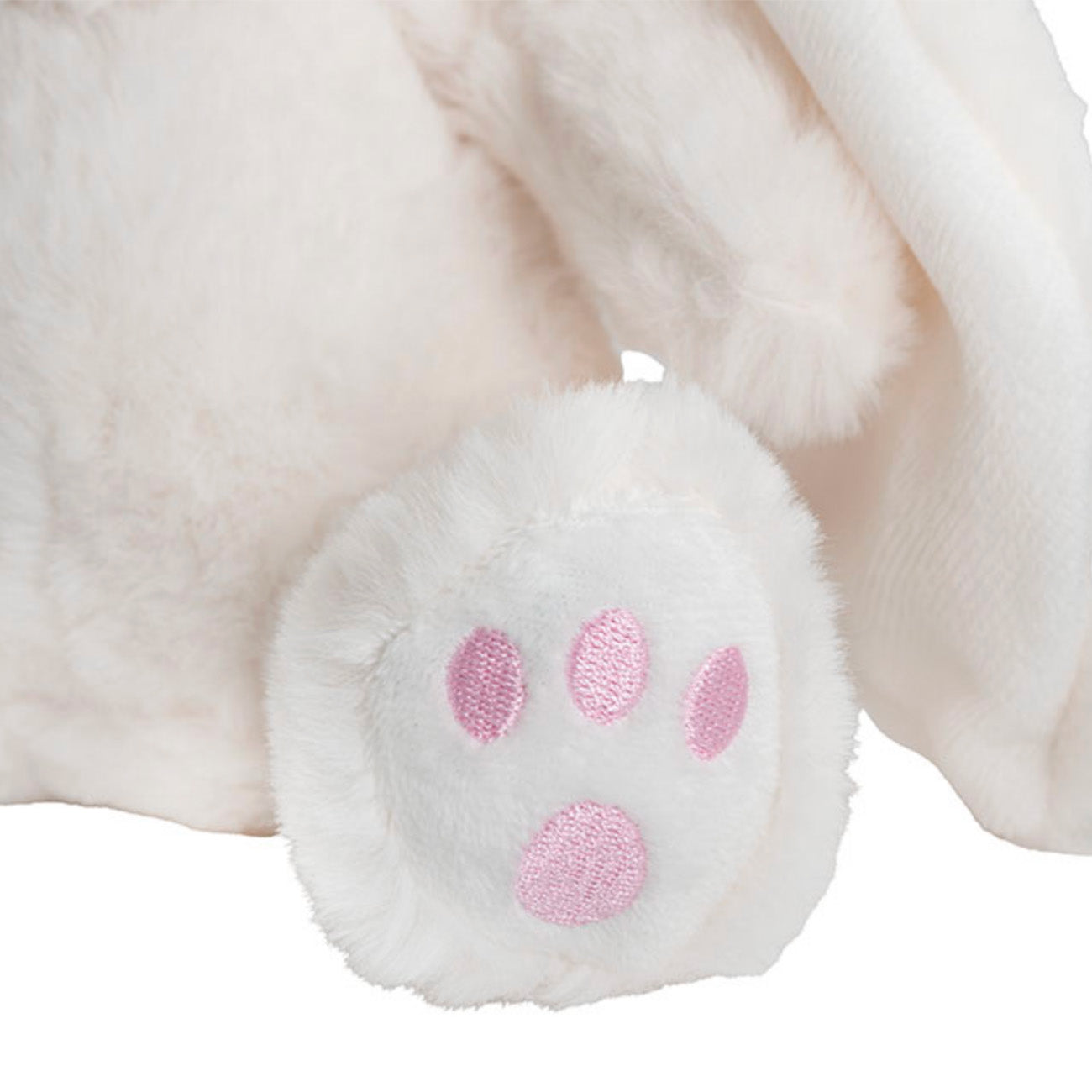 Close-up of a plush toy with pink paw prints on a white background