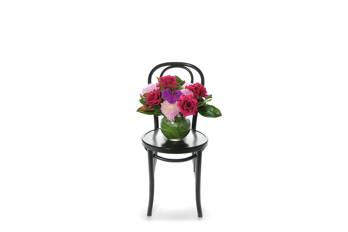 Kate Hill Flowers – bright pink ball-vase birthday design with chrysanthemums, reflexed roses and magenta orchid.