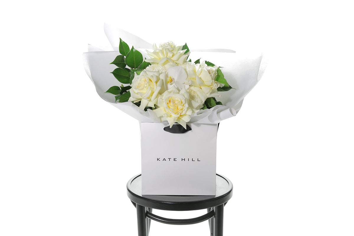 Kate Hill Flowers – medium lemon and white birthday bouquet with candlelight roses, hydrangeas, orchids and foliage hand-tied.