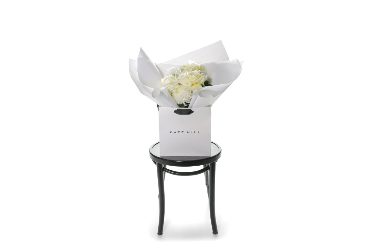 Kate Hill Flowers – small white and lemon congratulations posy of roses and chrysanthemums in a luxury flower bag.