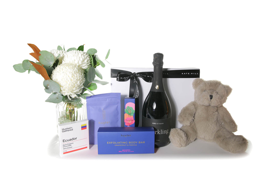 Flower gift box hamper featuring a chic flower vase design, chocolate, sparkling wine and a teddy bear.