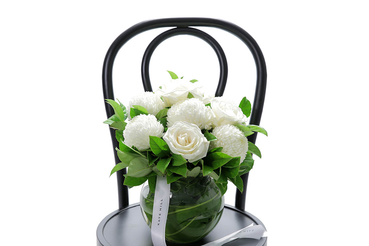 Close-up of ELISE ball vase with white disbuds and roses