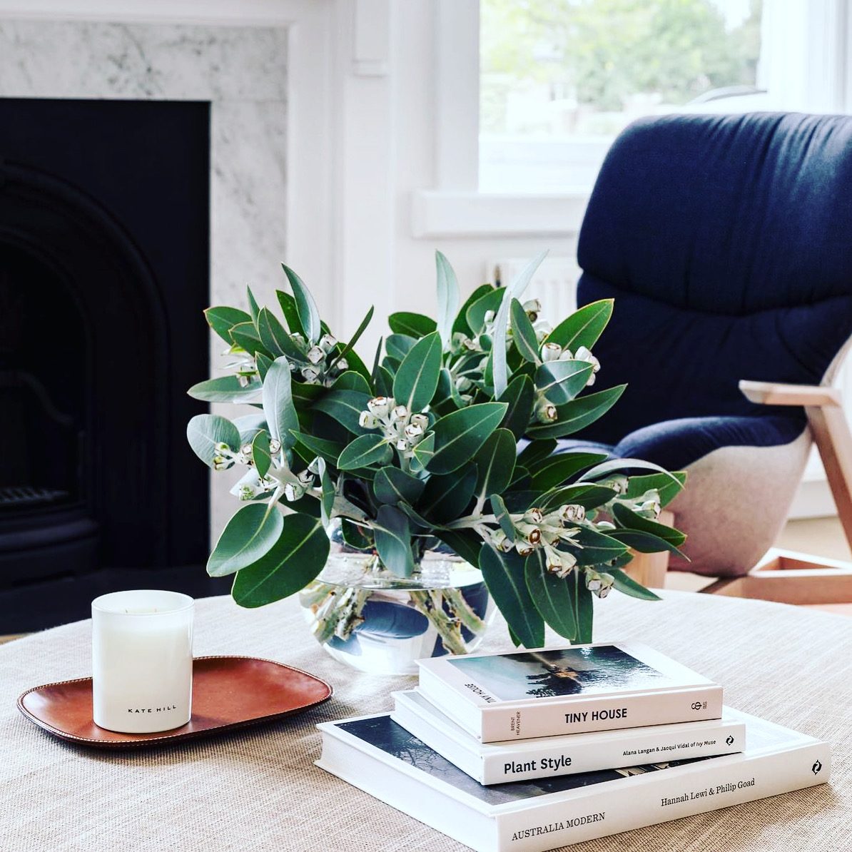 Flowering gum arrangement styled on a living room table