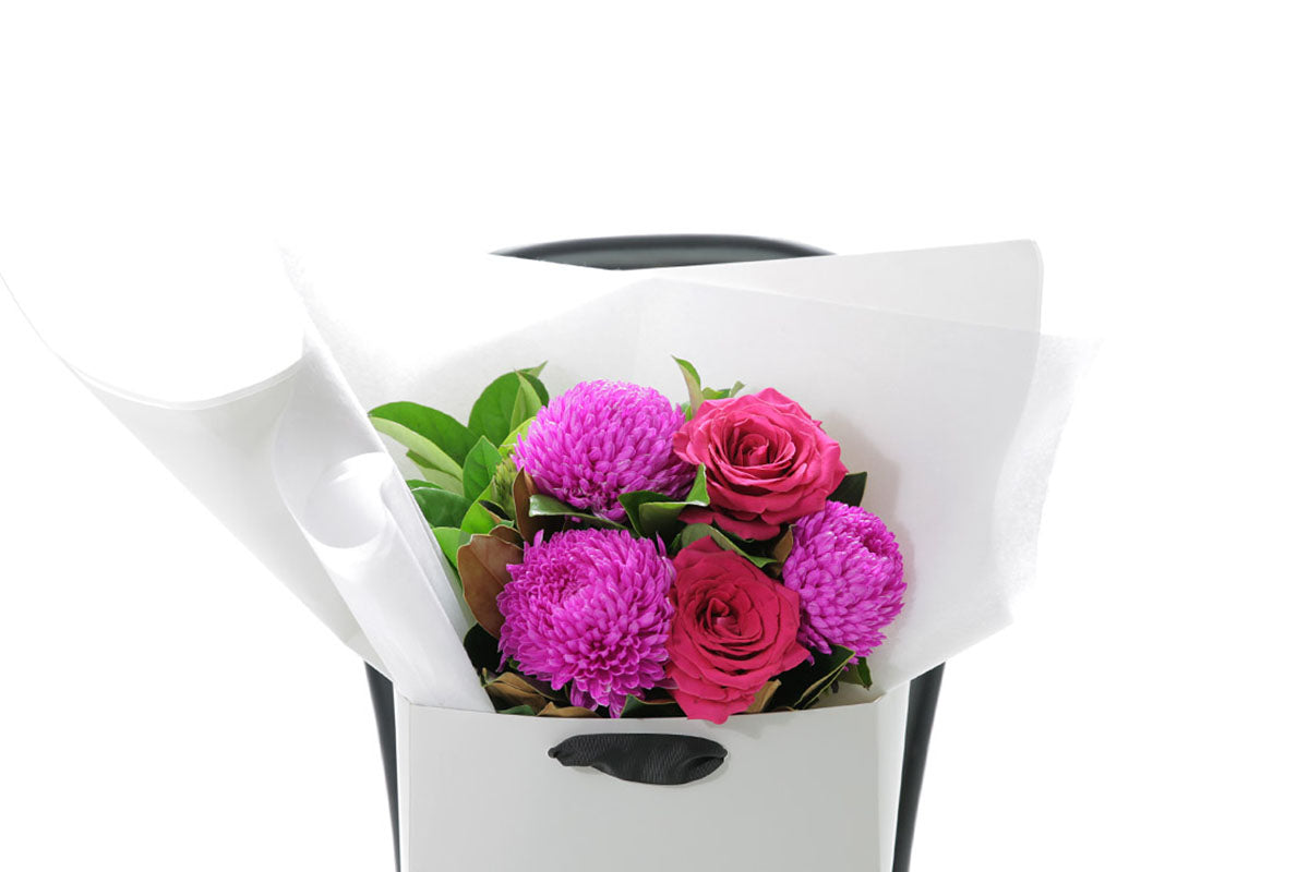 Close-up of LENI bouquet with hot pink and magenta seasonal blooms