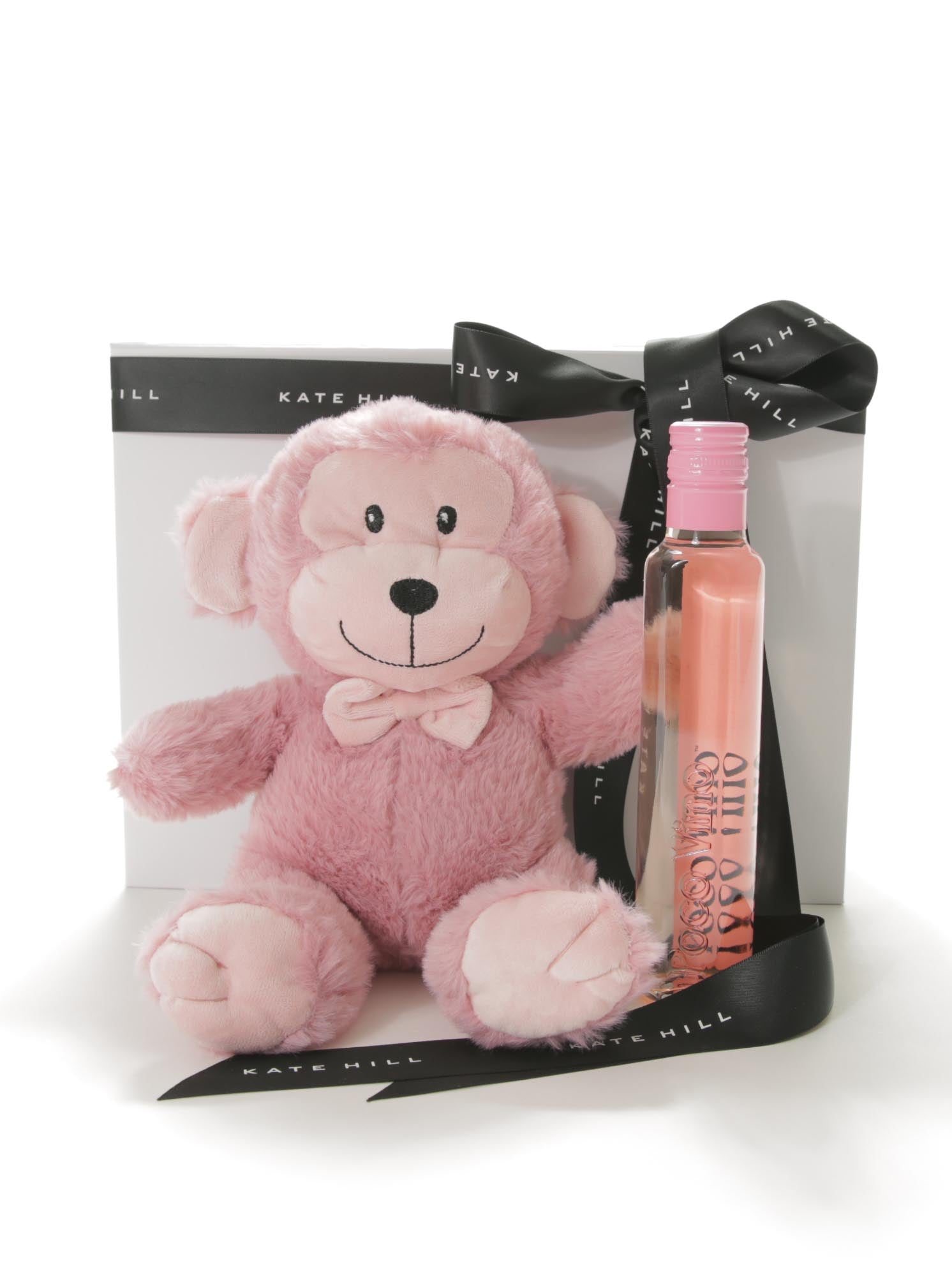 Pink teddy bear and bottle with Kate Hill branding in a gift bag.