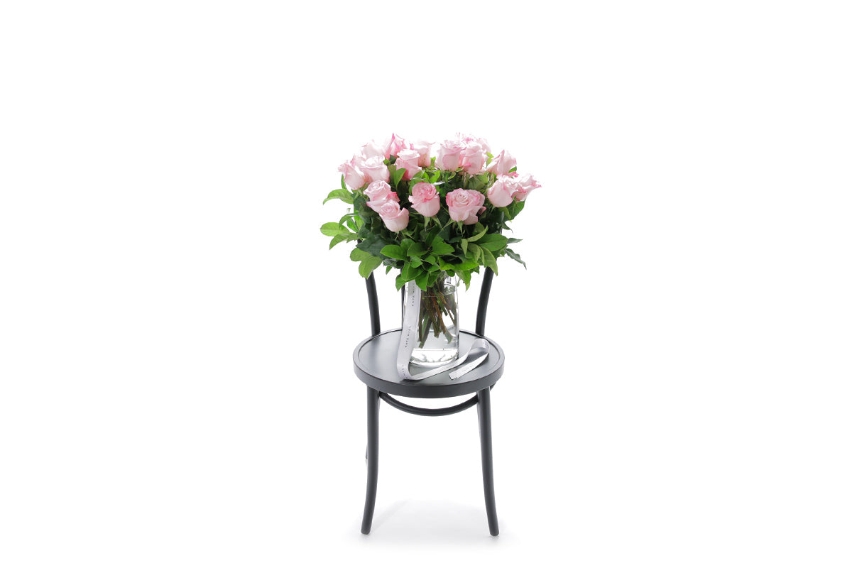 ZARA 20 soft pink roses in a tapered glass vase lined with monsteria