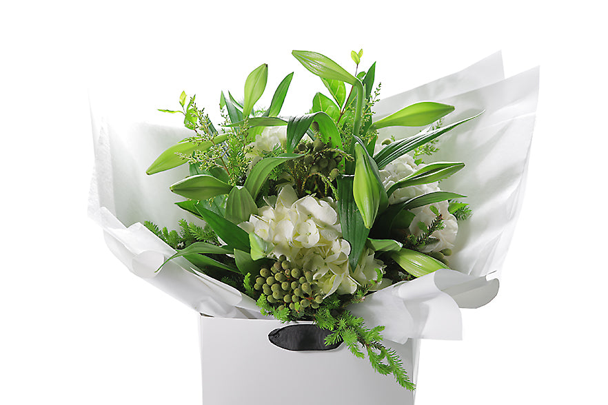 BETH Christmas Bouquet is packed full of festive and fragrant flowers that may include Christmas or Longiflorum Lilies, Hydrangeas, Berries and seasonal festive foliages (Spruce, Oak, Beech, Ivy Berry).  Our BETH Christmas Bouquet is delivered beautifully gift wrapped in Kate Hill Flowers signature wrapping and placed into our Kate Hill Flower Bag. Close up image of the bouquet  so you can view the quality of the flower bouquet.