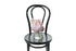 Petite ribbed glass vase displaying soft pastel pink seasonal flower. Gift includes the vase. Petite pastel vase is sitting on a black bentwood chair.