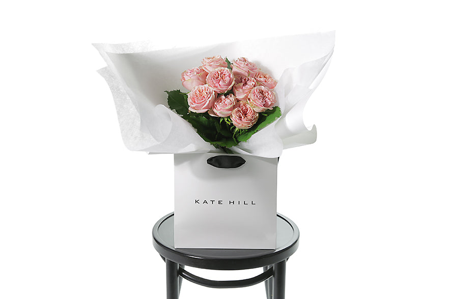 VERA is classed as a small sized, hand tied bouquet of 10 stems of Classic Roses (no additional foliage with roses only). Vera rose bouquet is beautifully wrapped in our signature wrapping and placed into our flower bag. Bouquet bag is sitting on a black bentwood chair.