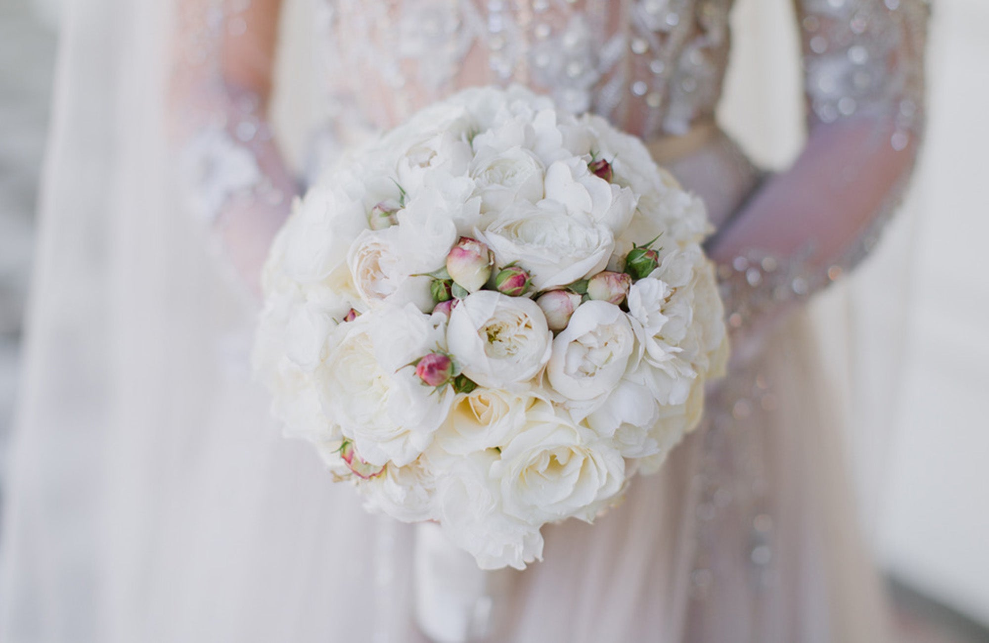 White bridal bouquet being held by bride