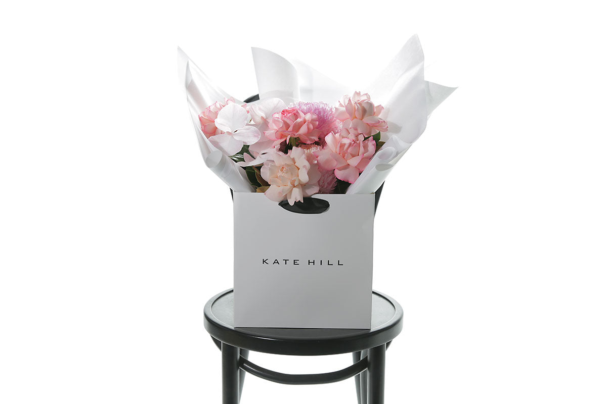 Bouquet of flowers in white flower bag by Kate Hill in Melbourne