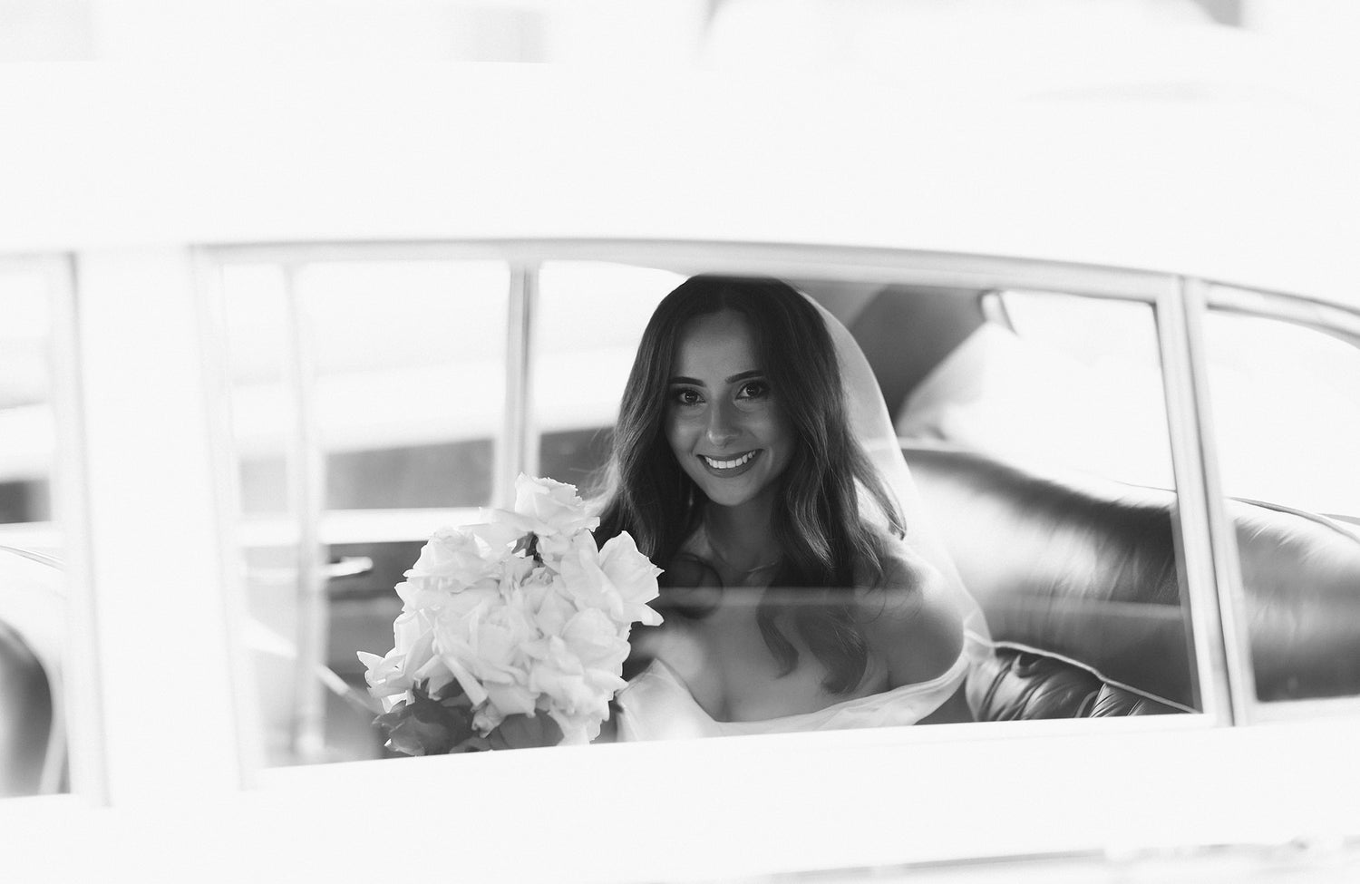 Melbourne bride holding a wedding bouquet in a wedding car