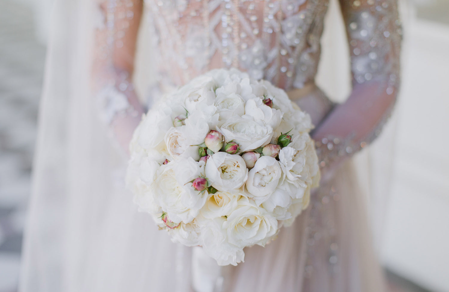 Close up of woman holding white bridal bouquet