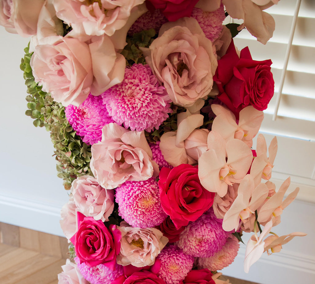 Close up of bridal shower flowers in pink hues