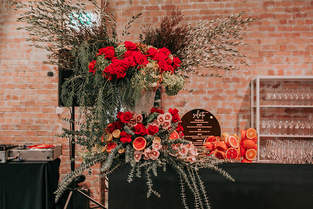 Red wedding flowers on the bar