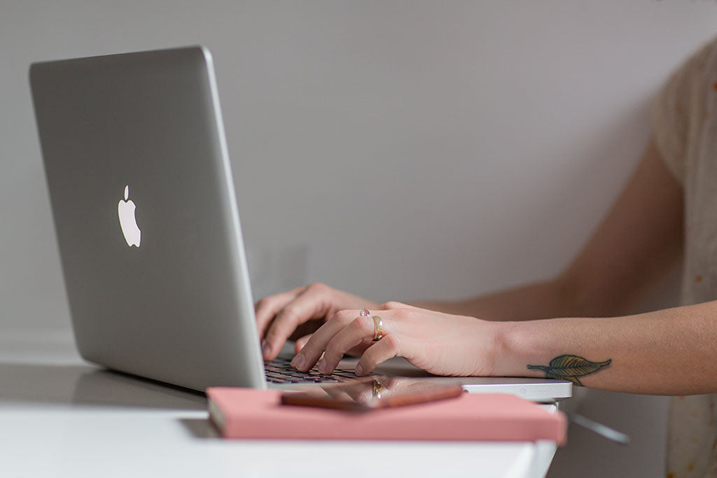 Woman on computer ordering a flower delivery in Melbourne from overseas