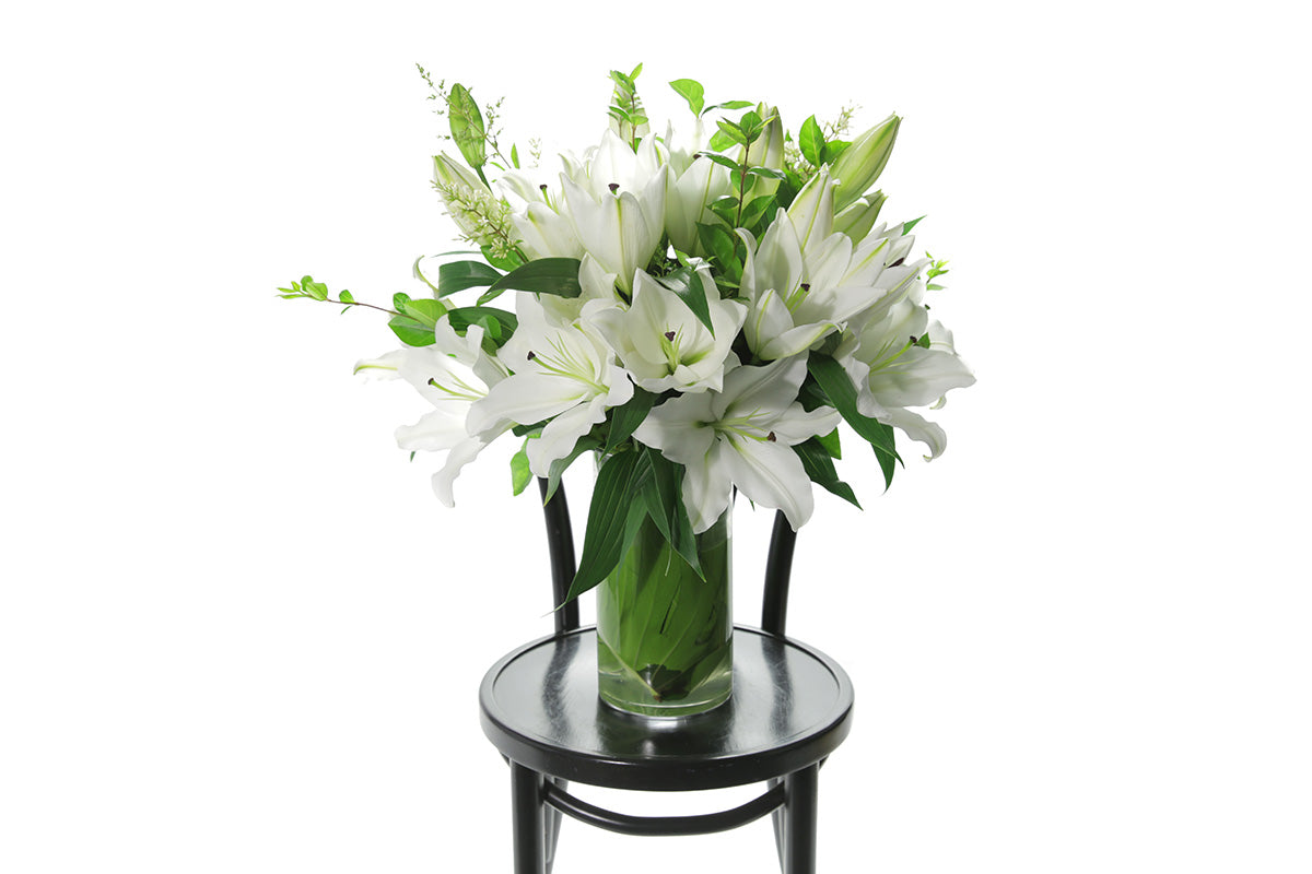 White lilies for flower Delivery across Melbourne arranged in a glass for us