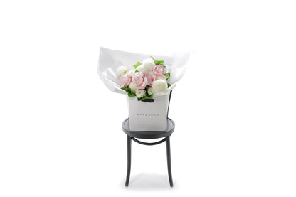 SERENITY small pastel flower bouquet in blush and white by Kate Hill Flowers Melbourne in black chair