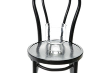Close up image of 20cm glass compote vase. A 20cm glass compote vase sitting on a black bentwood chair with white background.