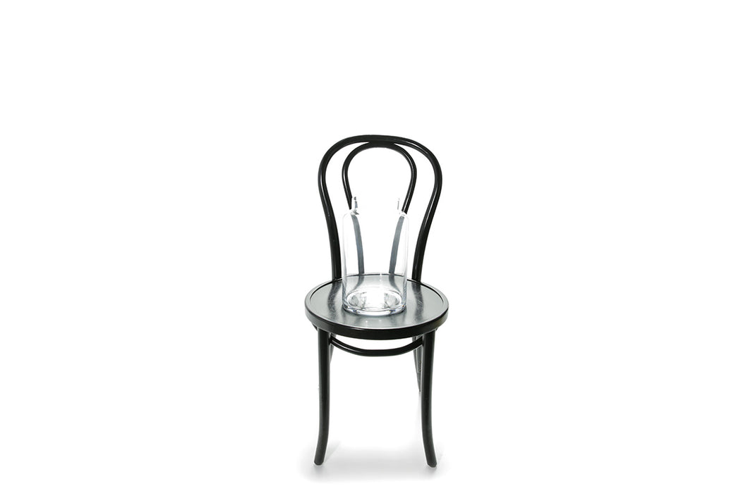 30cm lipped cylinder vase sitting on a black bentwood chair with a white background.