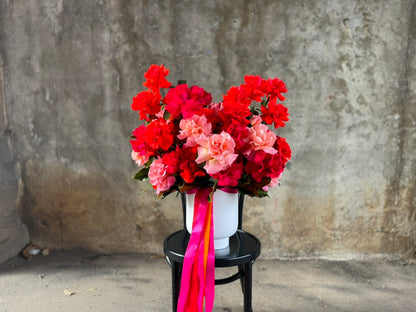 Wide view of florist holding the luxe design of reflexed roses.