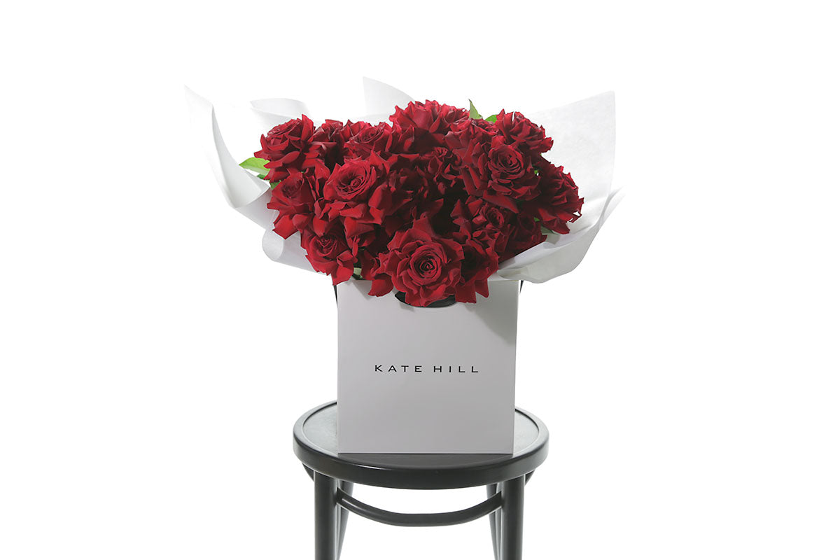 Red rose bouquet in white Kate Hill flower bag