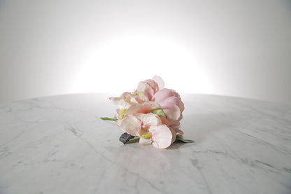 Kate Hill Flowers – pink spray rose buttonhole flowers with black-taped stem and pearl pin on marble table setting.
