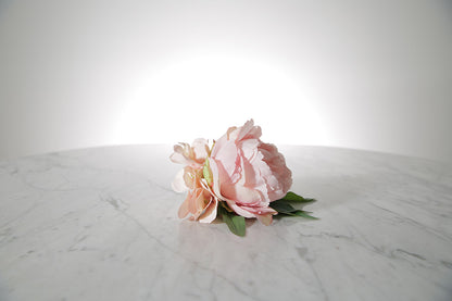Kate Hill Flowers – pink spray rose buttonhole flowers with black-taped stem and pearl pin on marble table setting.