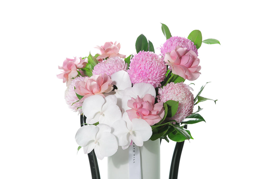 Kate Hill Flowers – large soft-pink ceramic vase arrangement with roses, chrysanthemums, orchids and rich greenery.