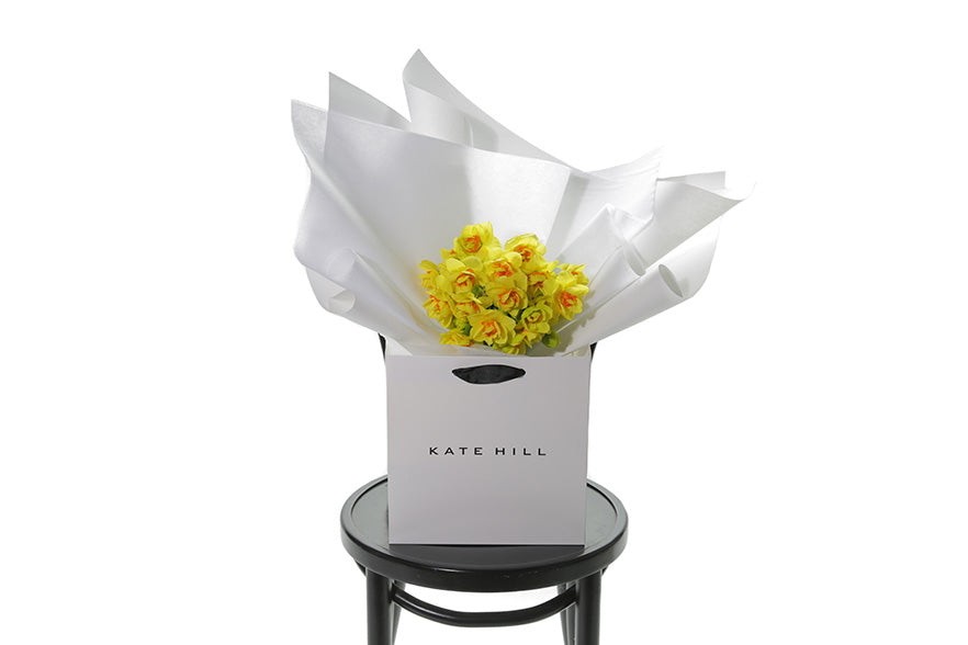 Petite posy of wrapped Daffodils, sitting on a black bentwood chair. Classed as a small in size, the DAFFODIL is a hand tied collection of 3 bunches of DAFFODILS which are beautifully gift wrapped in our signature wrapping. Yellow double daffodils in image.