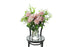 Soft blush pink reflexed roses displayed in a clear glass tapered vase sitting on a black bentwood chair with white background. 