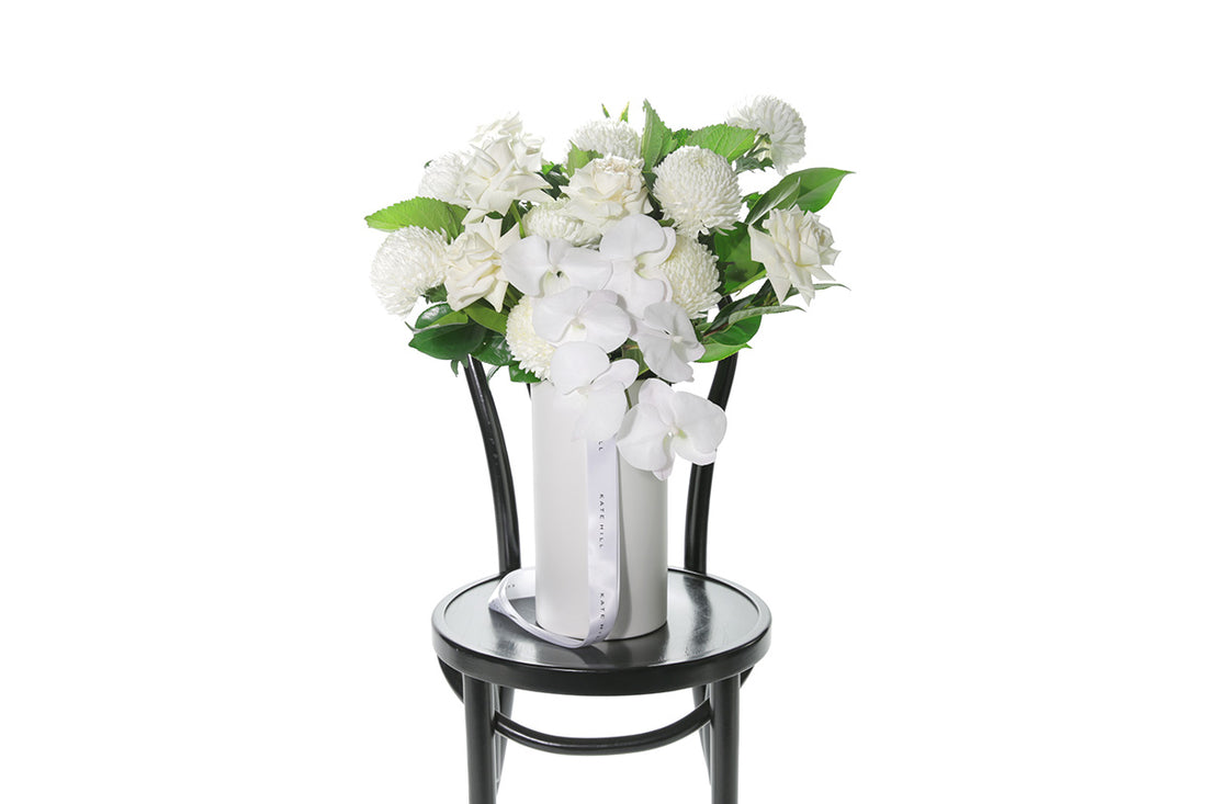 Kate Hill Flowers – large white and green ceramic vase with roses, chrysanthemums and orchids.