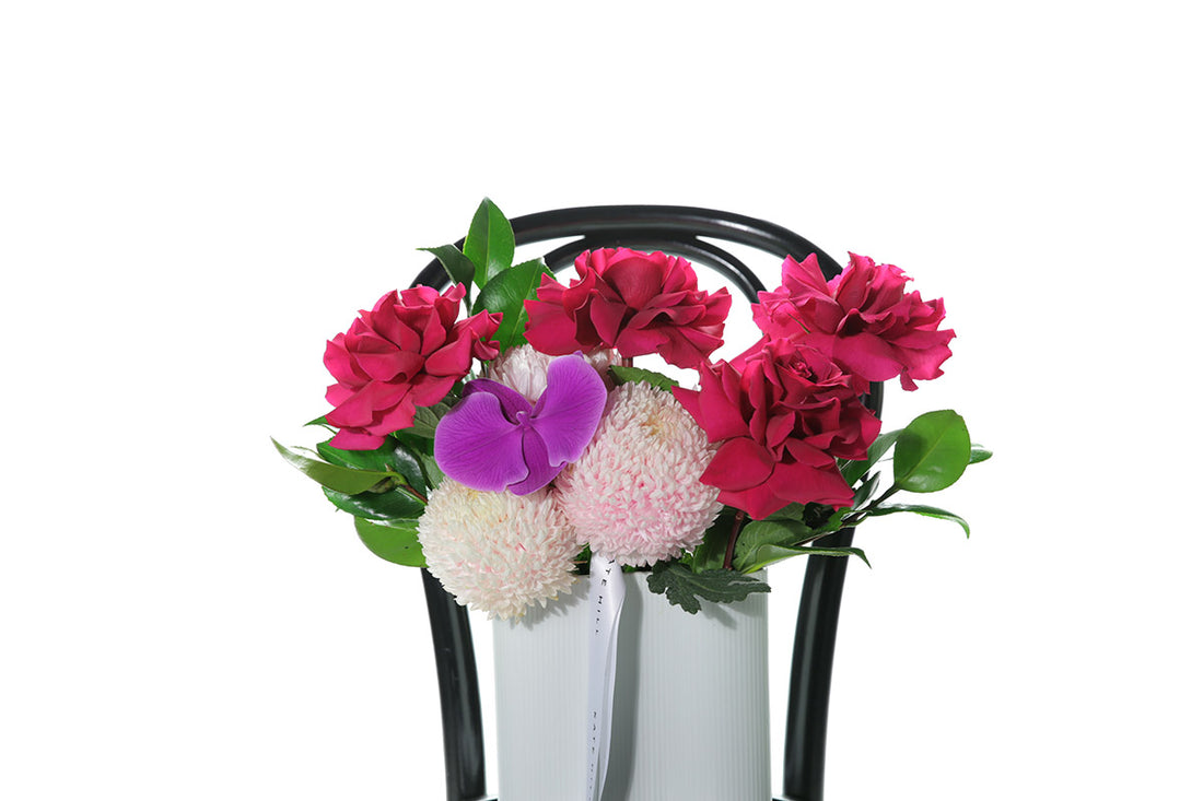 Kate Hill Flowers – medium white-wave vase with hot-pink chrysanthemums, reflexed roses and magenta orchids for congratulations gift.