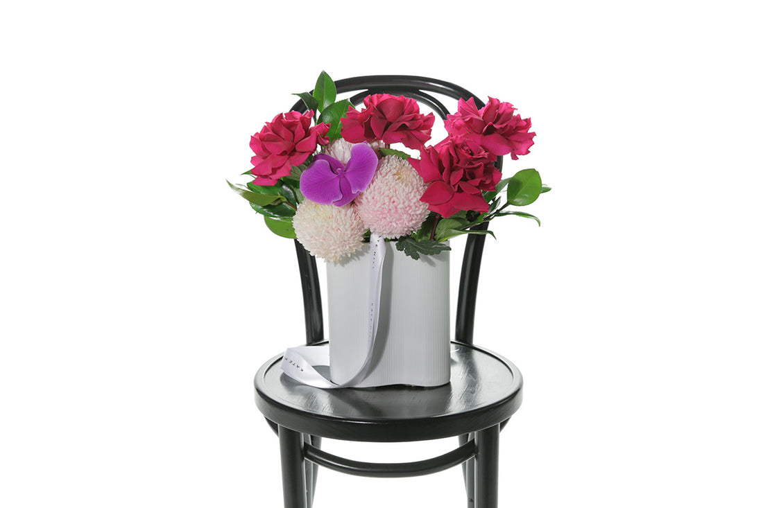 Kate Hill Flowers – medium white-wave vase with hot-pink chrysanthemums, reflexed roses and magenta orchids for congratulations gift.